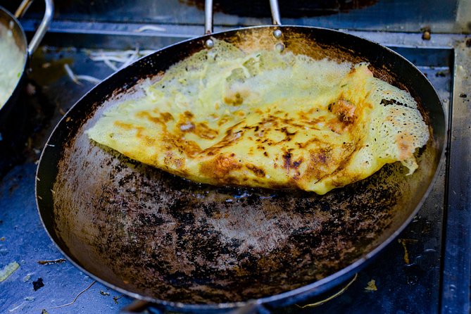 Private Street Food Evening Walking Tour in Ho Chi Minh City - Stop 1 at Street Food Man: Rice Pancakes and Leaving Tourist Streets Behind